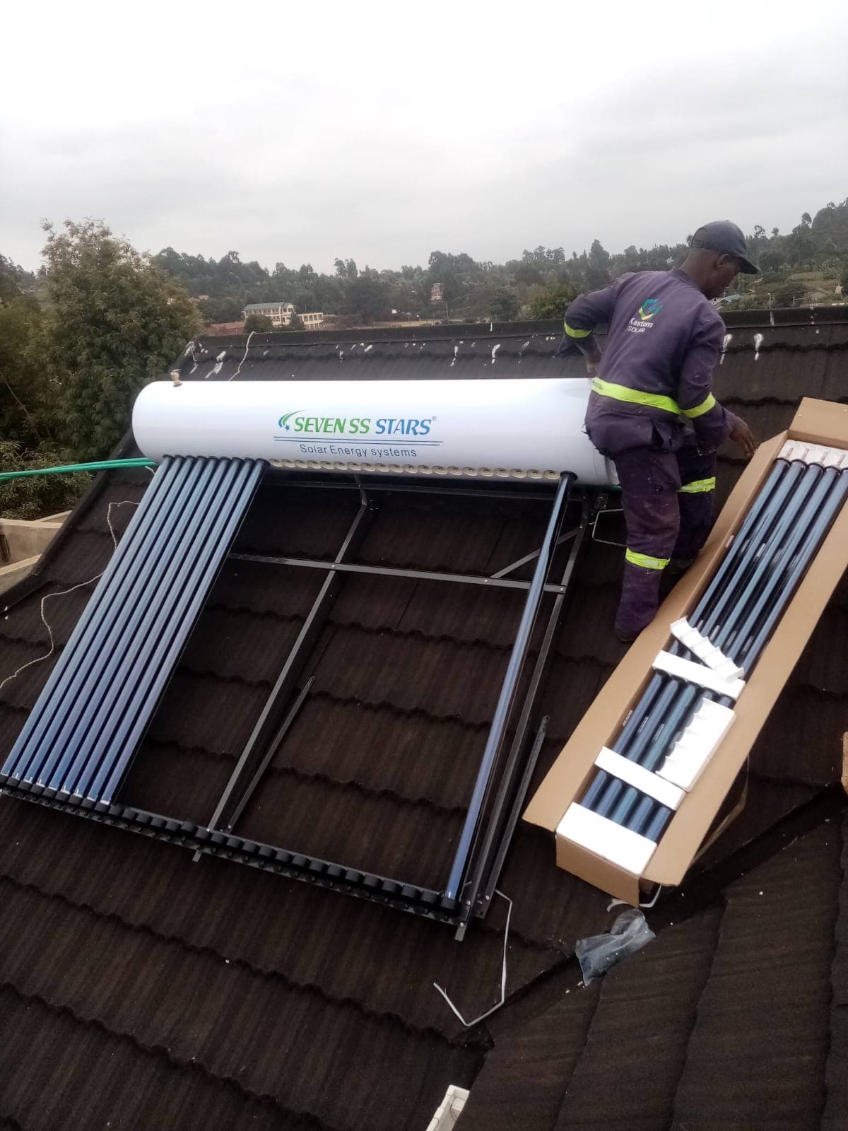 Technician fitting solar water heater tubes on site