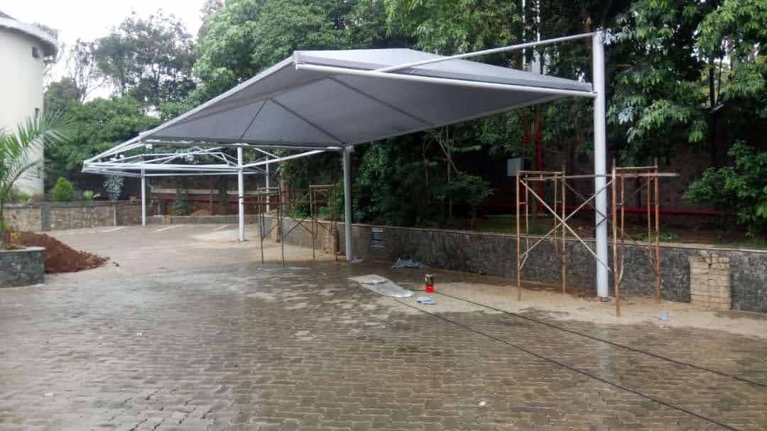 Cantilever car parking shade structure mid-installation with scaffolding still in place, Malindi
