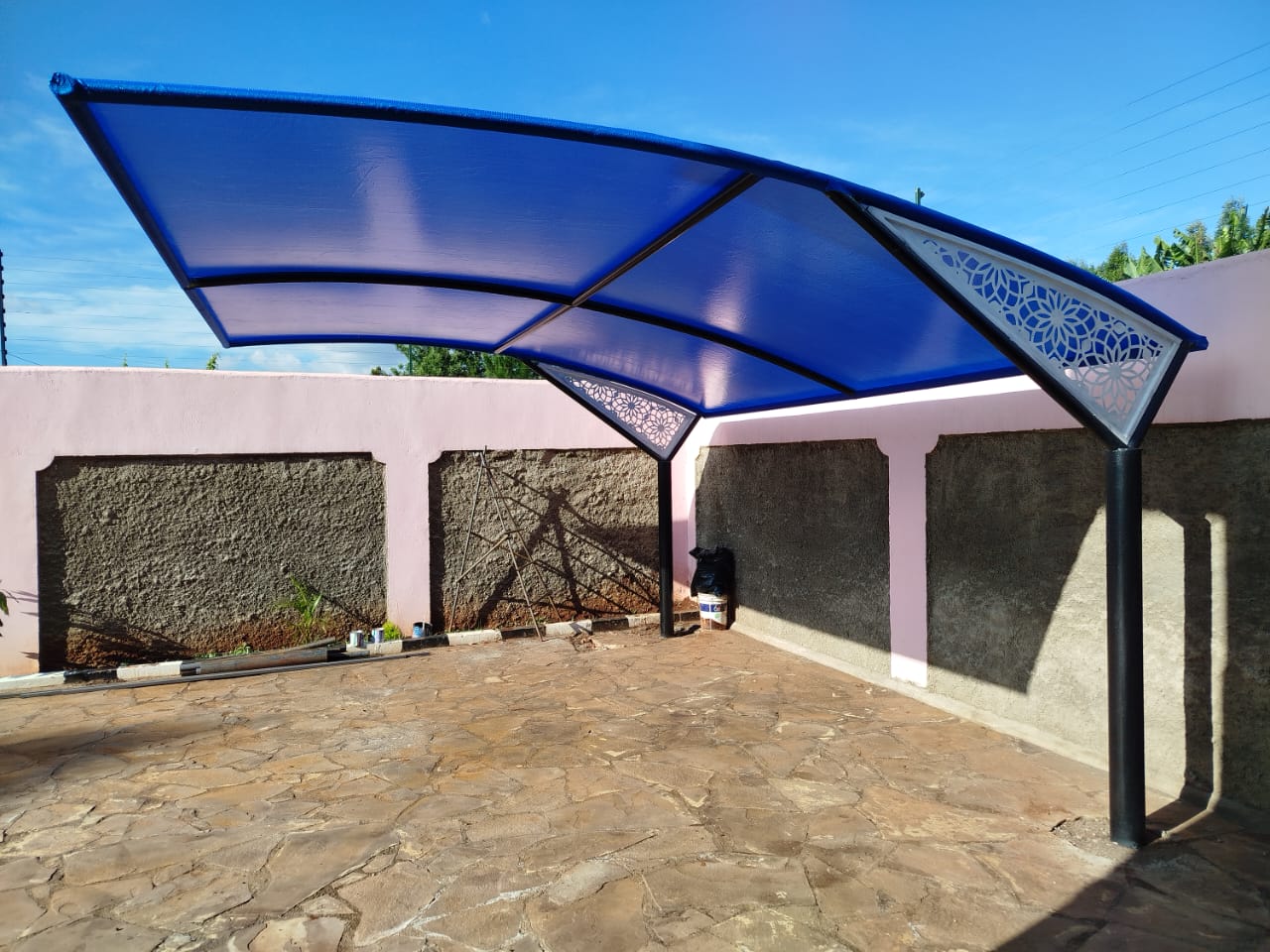 Blue cantilever car parking shade structure at a Runda property, alternate angle showing full canopy span