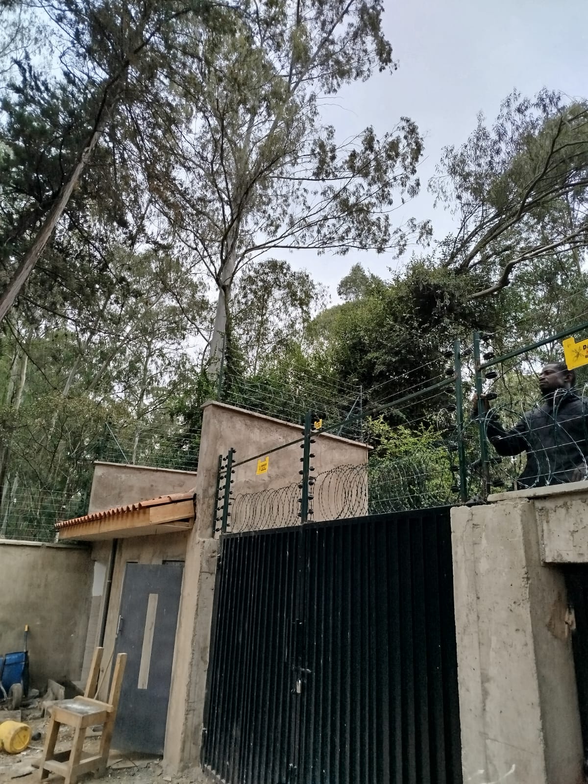 Electrical control cabinet with wiring for an electric fence and solar siren system mounted at a Karen property