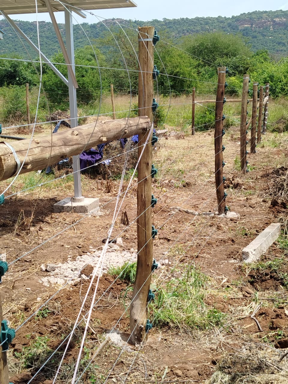 Solar panel structure mounted at the electric fence line near Voi, providing independent power supply