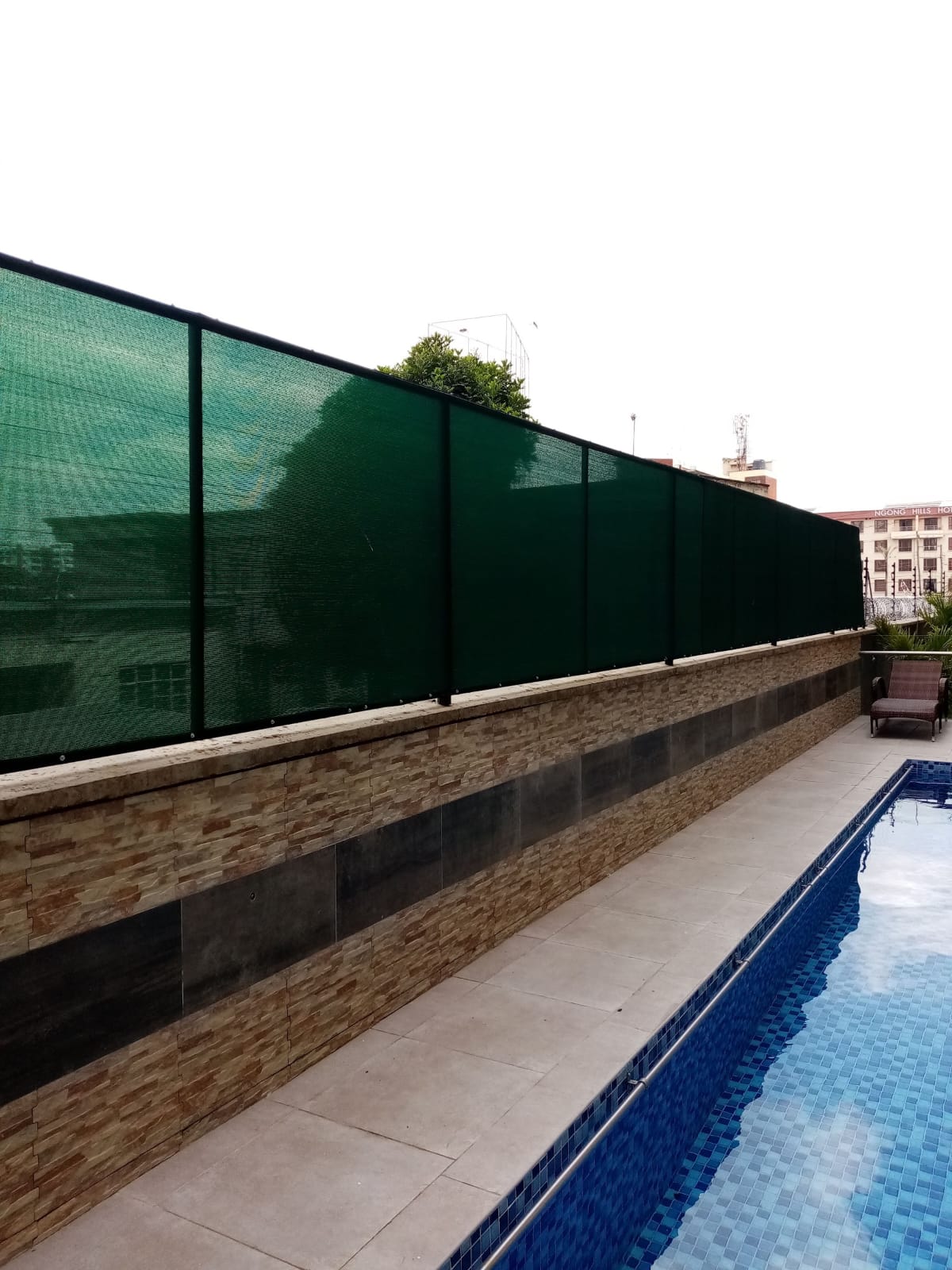 Rooftop pool privacy shade screen and stone-clad parapet wall, alternate angle, Nyali