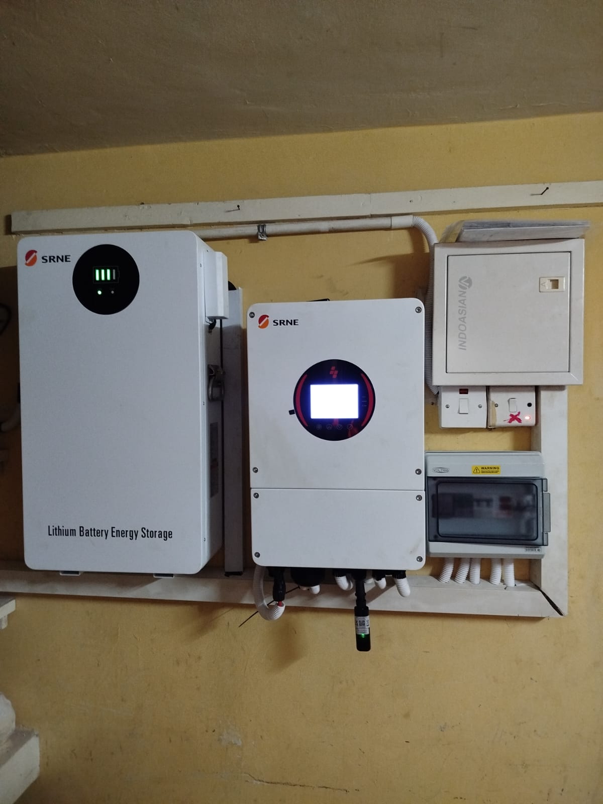 SRNE lithium battery storage and hybrid inverter wall-mounted with distribution board at a Nairobi apartment complex