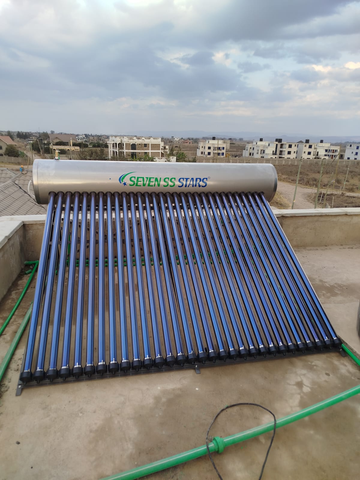 Finished Seven SS Stars solar water heater tank and collector tubes on a tiled Katani rooftop