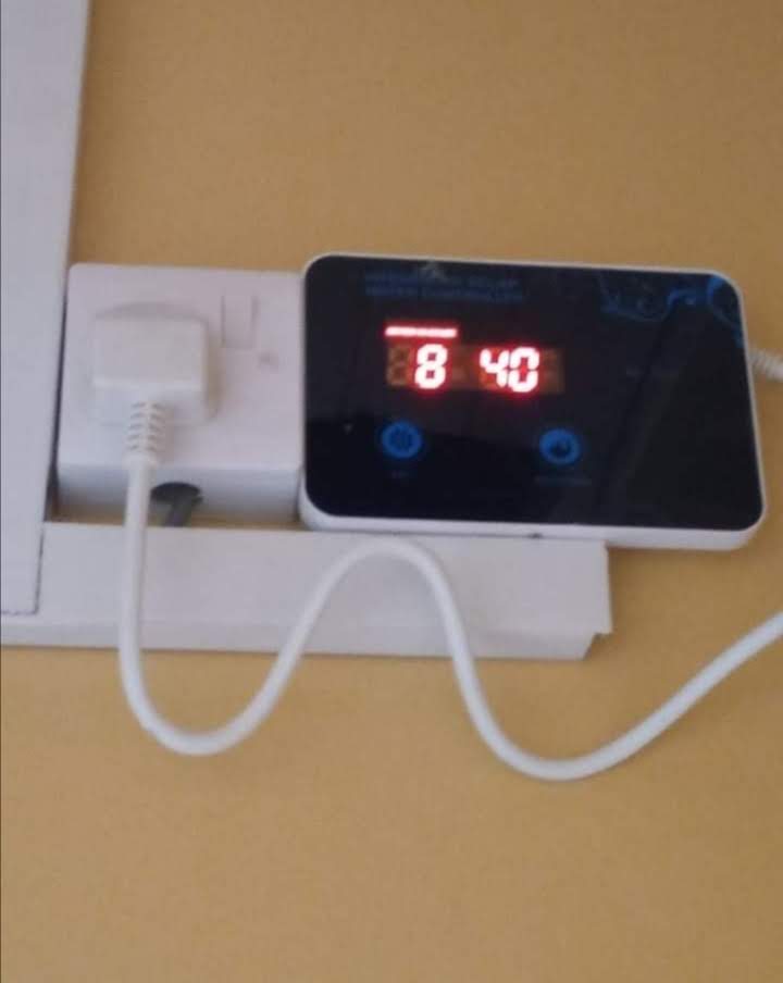 Digital solar water heater controller displaying tank temperature, wall-mounted indoors at a Nairobi property