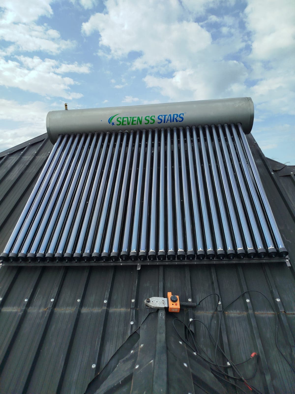 Finished 300L Seven SS Stars evacuated-tube solar water heater on a metal roof in Nyahururu